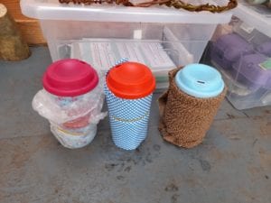 three-eco-cups-with-different-insulating-materials-secured-around-their-outsides.